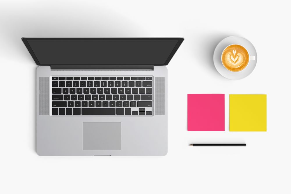 Modern workspace with coffee cup, smartphone, paper, notebook, tablet and laptop copy space
