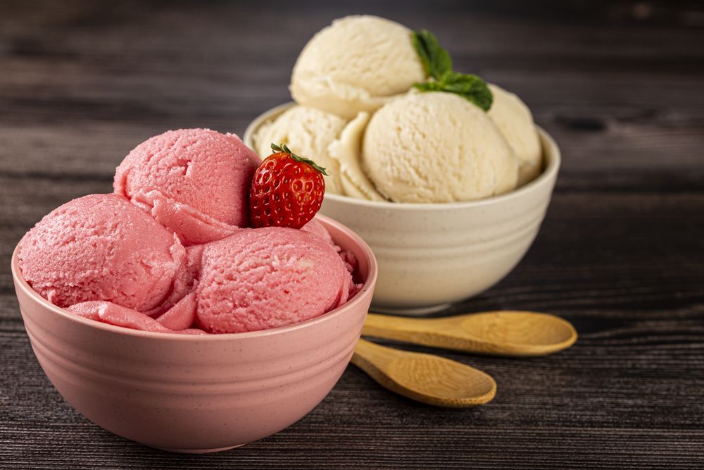 Bowls with strawberry and vanilla ice cream.