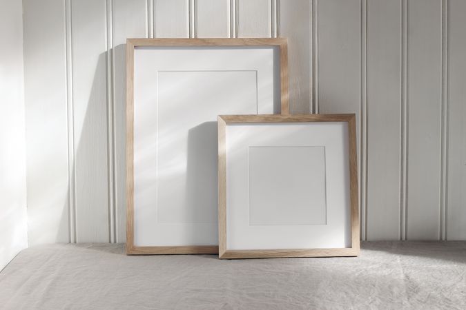 Set of blank vertical and square wooden picture frame mock ups in sunlight.