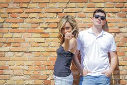 Couple portrait in front of brick wall