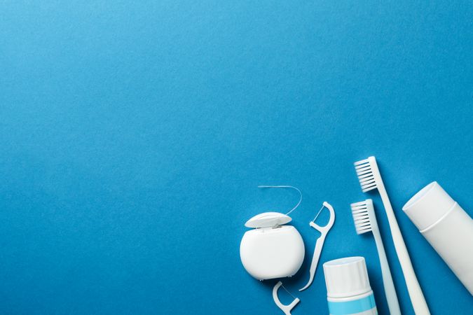 Tools for dental care on blue background, space for text