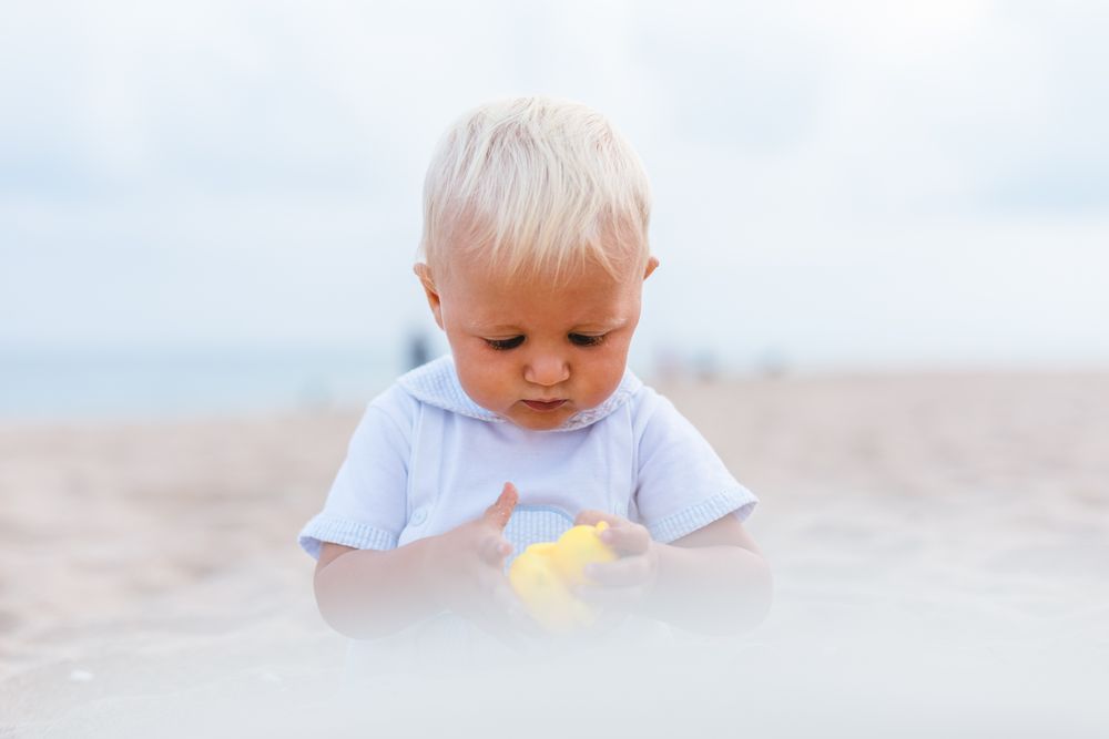 Baby boy playing with rubber ducks
