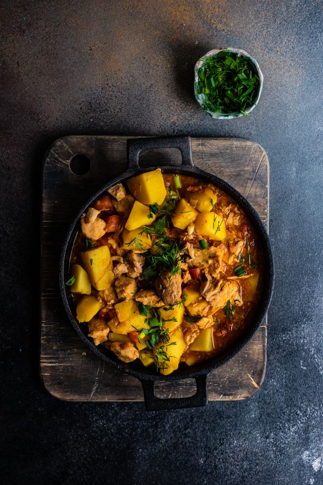 Top view of hearty Georgian meat and vegetable stew Souzi served with herb