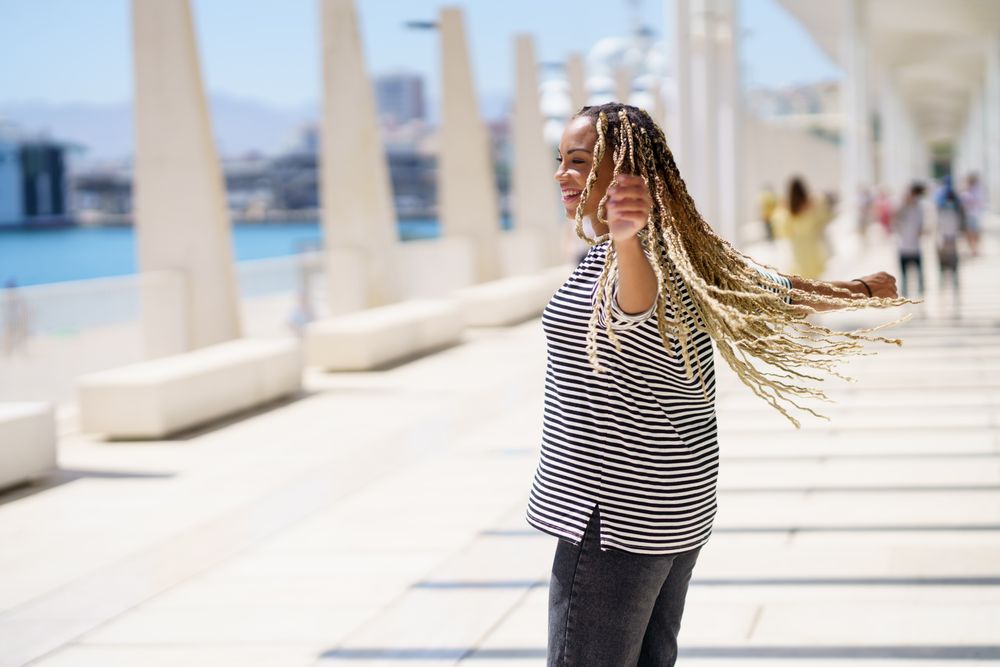 Carefree woman turning around in bright outdoor area