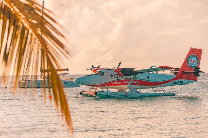 Seaplane parks next to a boat