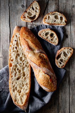 Fresh baguettes on checkered towel