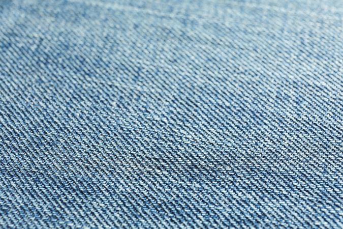 Texture of blue jeans as background, space for text