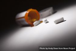 Medicine Bottle and Pills Under Spot Light 0Pj1B2