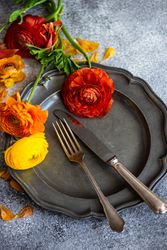 Rustic table setting with grey plate and fresh flowers