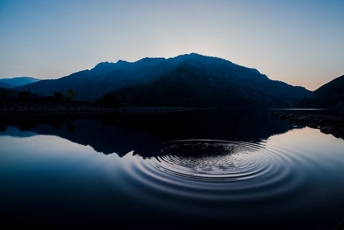 Wonderful lake between hills and blue sky at sunset