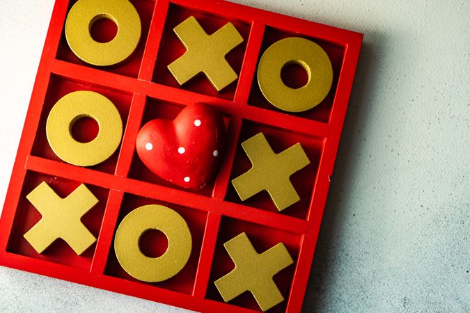 St. Valentine day card concept with red dotted heart in center of tic-tac-toe game
