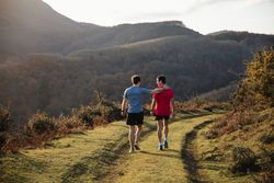 Sportive males taking break after running in mountains