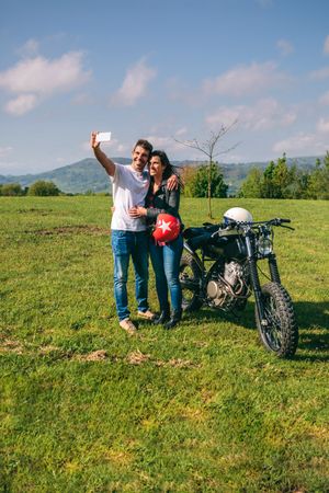 Couple taking a selfie with a motorcycle