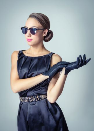 Chic model in vintage dress and gloves