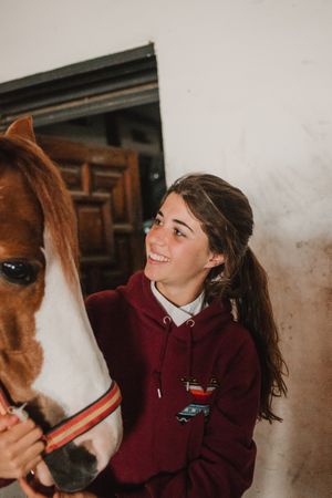 Girl with adorable pony in hat