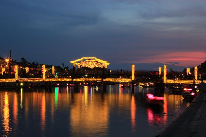 Lit city with reflection on water