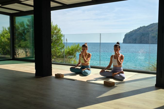 Peaceful women breathing while sitting in Lotus pose