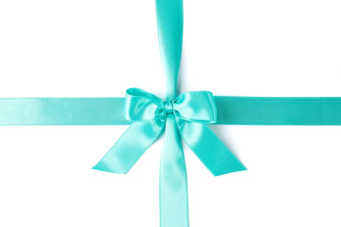 Turquoise ribbon with bow isolated on plain background. Gift concept