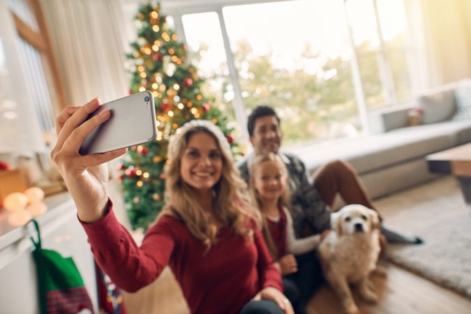 Happy family taking self portrait during Christmas at home