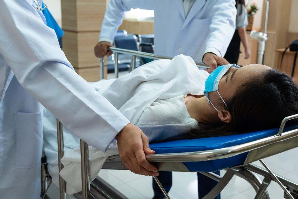 Sick woman wearing protective mask in hospital