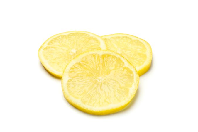 Lemons slices isolated on light background. Ripe fruit