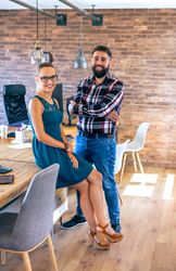 Partners looking at camera posing in the office