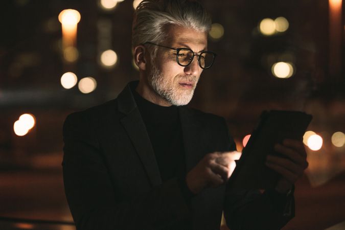 Business executive working on tablet computer late night in office