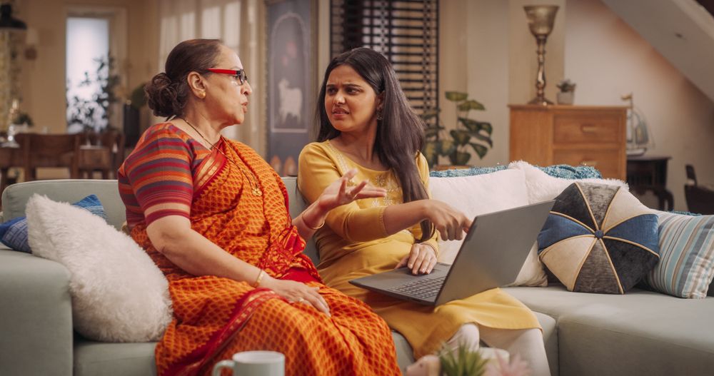 Indian Mother and Daughter Use Laptop at Home