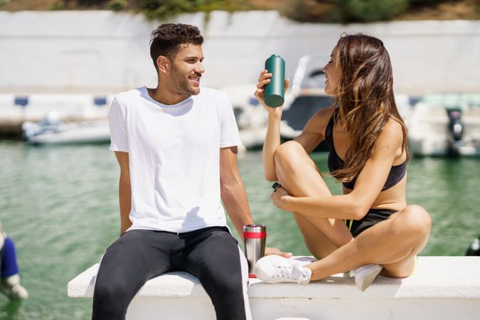 Couple chatting on pier on sunny day