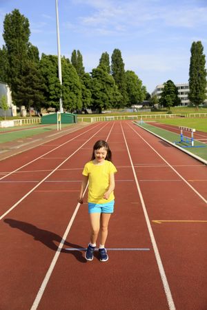 Child jogging on running track at school