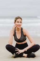 Woman meditating on the beach