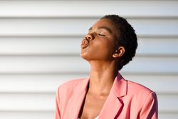 Side view of female making kissing face with eyes closed