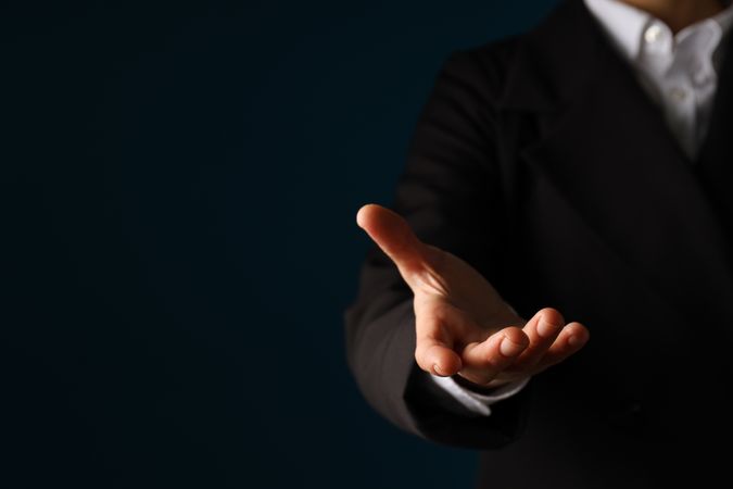 Businessman's hand close-up on a dark background