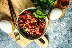 Top view of healthy beetroot salad on grey counter with copy space