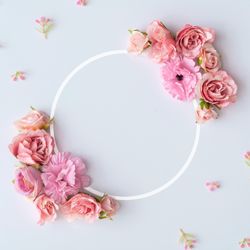 Creative layout made of colorful spring flowers and illuminated circle