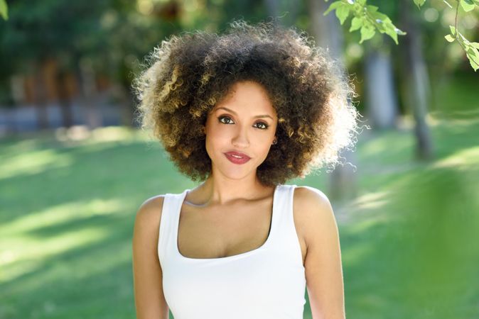 Portrait of Black woman with afro hairstyle walking through park