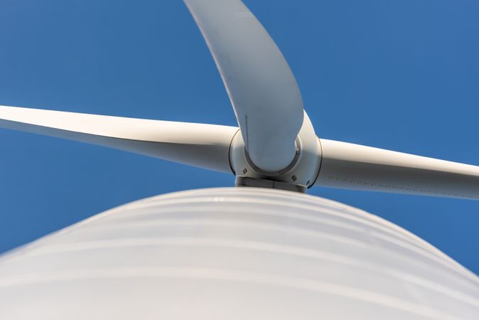 Modern wind turbine low angle view, directly below, against the blue sky