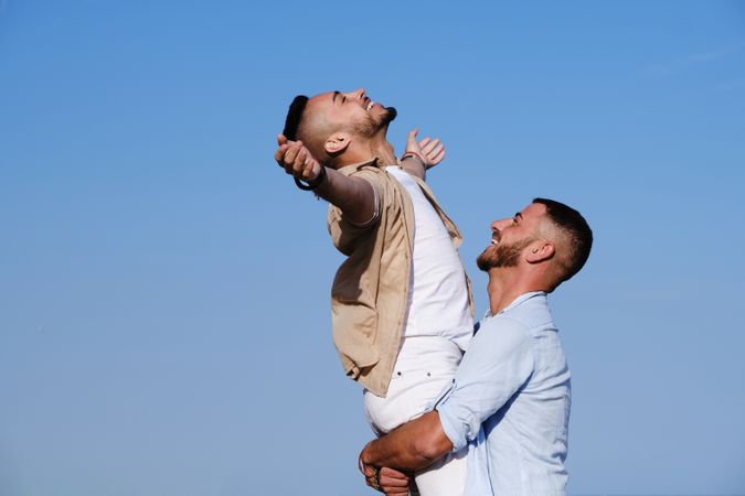 Happy gay couple enjoying and embracing outdoors
