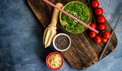 Green smoothie on concrete background with copy space