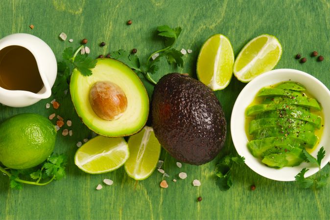 Ingredients for an avocado dish on green table