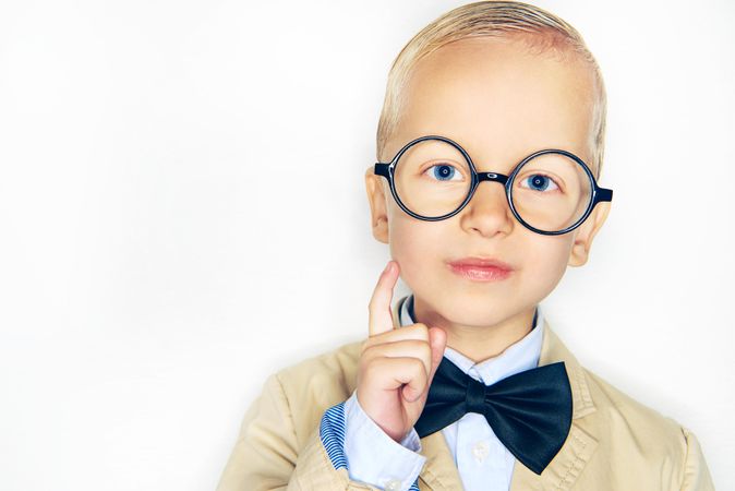 Cute blond boy in glasses and bow tie