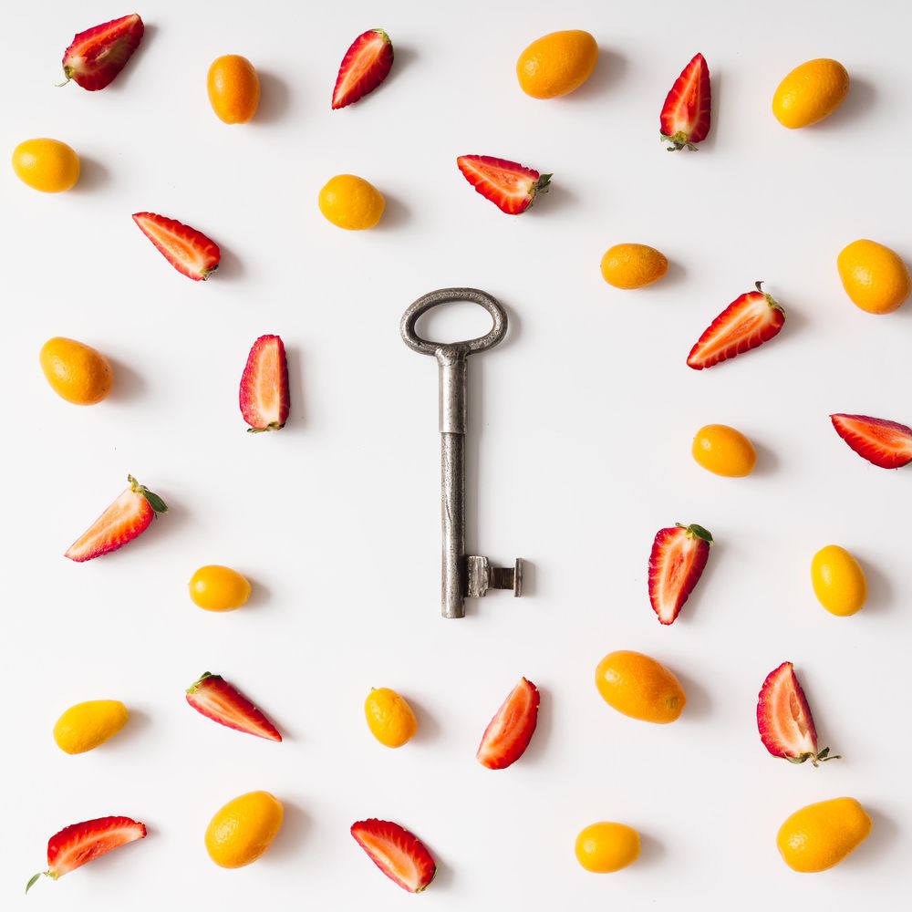 Pattern made of kumquats, strawberries with key