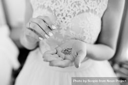 Grayscale photo of bride holding a jewelry 0VLWY4