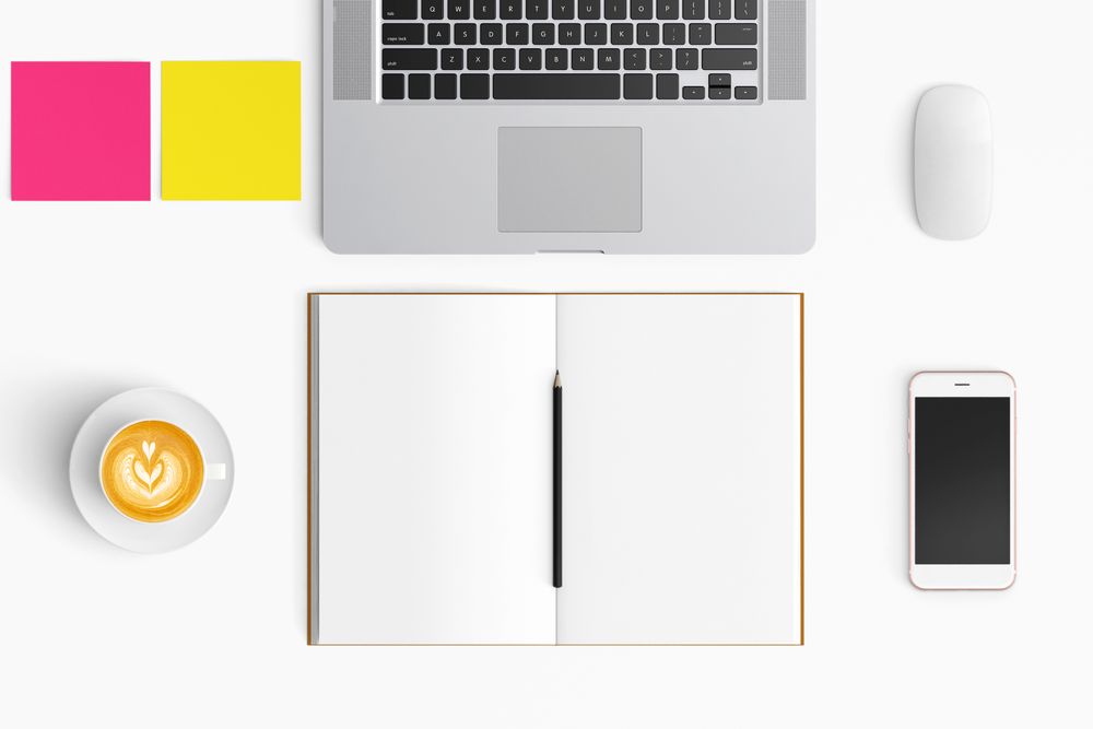 Modern workspace with coffee cup, smartphone, paper, notebook, tablet and laptop