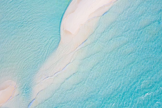Wide shot of clear blue water and sand in the Indian Ocean, landscape