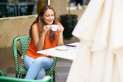 Latina woman enjoying morning coffee outdoors