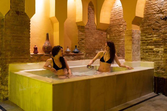 Friends bathing together in Arabic bathhouse