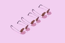 Three sunglasses on pastel background