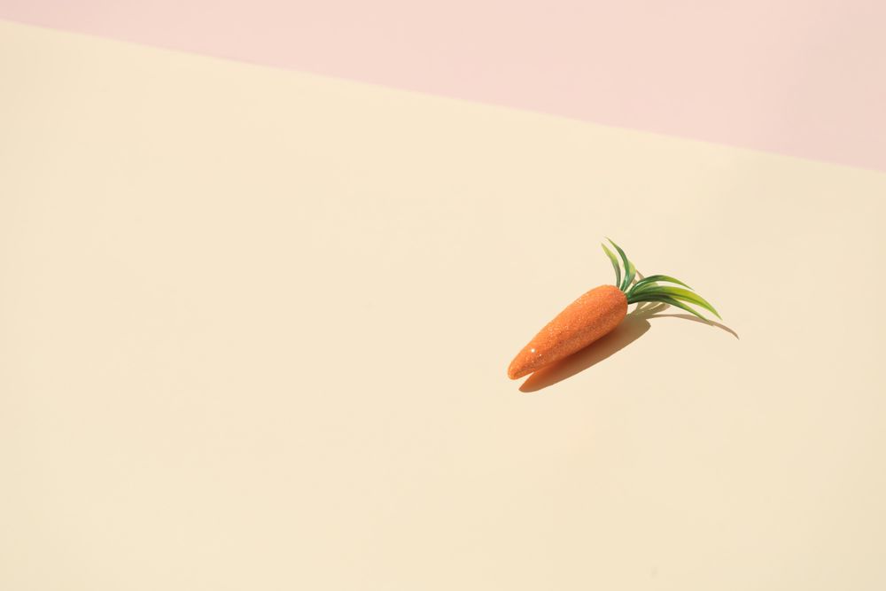 Carrot on pastel yellow background