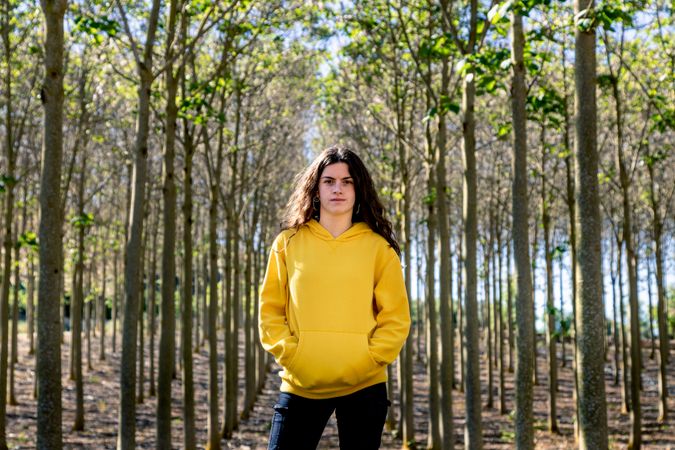 Young sporty girl standing in forest